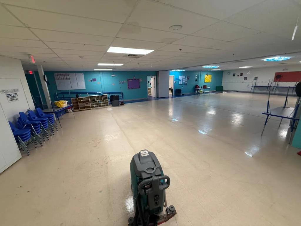 Wide view of a multipurpose room after a full machine scrub and floor restoration